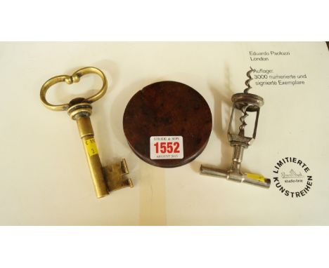 An early 19th century treen circular snuff box and cover, 9cm diameter; together with a novelty brass 'key' corkscrew; and an