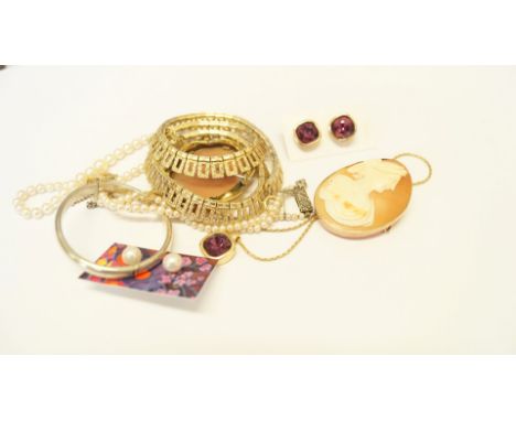 A small collection of jewellery to include; two cameo brooches; a silver child's hinged bangle; a pearl necklace and studs; a