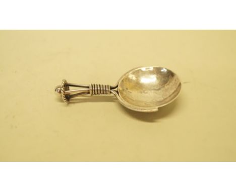 An Arts & Crafts silver tea caddy spoon, by A E Jones, Birmingham 1919. Condition Report: The Caddy Spoon is in good clean or