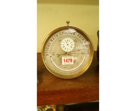 An unusual early 20th century brass cased combination timepiece and aneroid barometer, 16cm high.  Condition Report: Does not