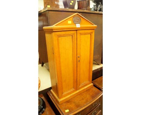 An early 20th century oak 'Army & Navy' tool cabinet, of architectural form, 66cm high. 