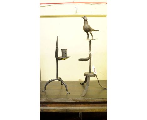 A steel tripod rush light candlestick; together with a Persian steel tripod rush light and oil lamp. 