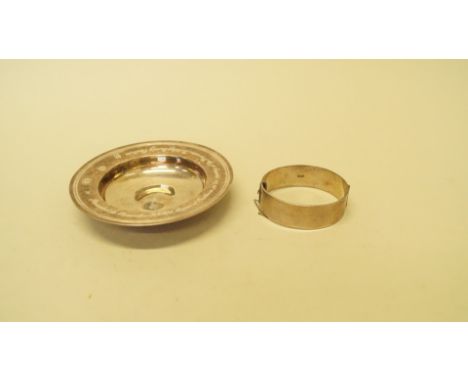A silver Armada dish, engraved presentation and a silver hinged bangle, 178g.