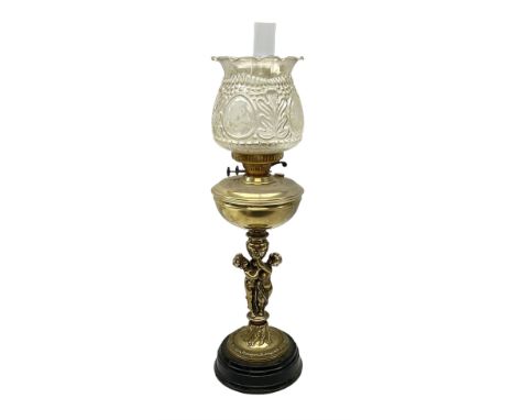 Late 19th/early 20th century brass oil lamp, the central column modelled with two cherubs, supporting the reservoir with wyrt