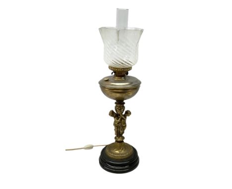 Late 19th/early 20th century brass oil lamp, the central column modelled with two cherubs, supporting the reservoir with fril