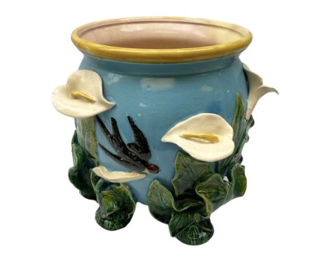 George Jones style majolica jardiniere of globular form, supported on four feet formed from modelled lily leaves growing up t
