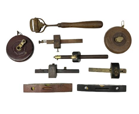 Quantity of tools to include two leather cased tape measures, together with four mortice gauges, brass mounted spirit levels 