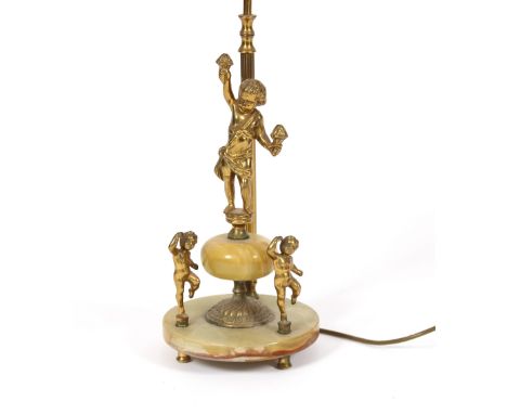 An onyx and gilt metal table lamp with cherub decoration and red silk shade 