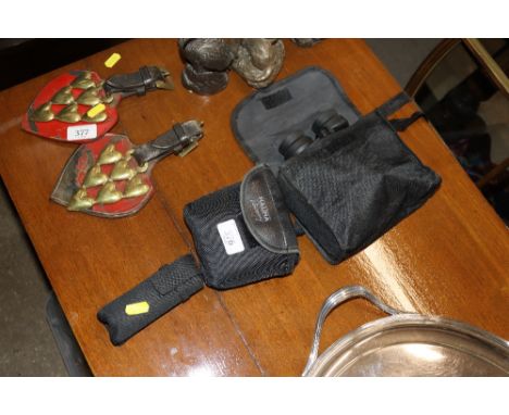 A pair of Bushnell binoculars; a pair of Halina binoculars and a monocular 