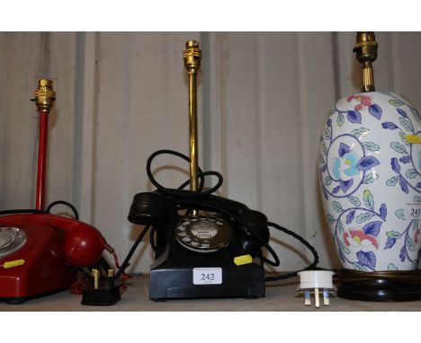 a table lamp in the form of a vintage dial telephone 