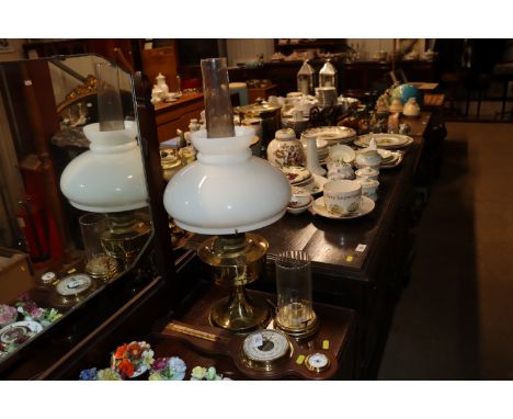 A brass table oil lamp with opaque glass shade; a small brass and glass chamber stick and a barometer 