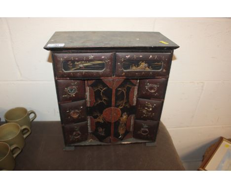 An Oriental lacquered trinket cabinet