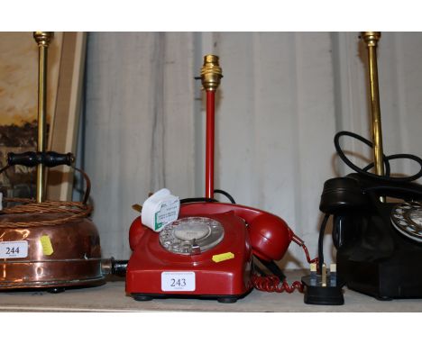 A table lamp in the form of a red vintage dial telephone