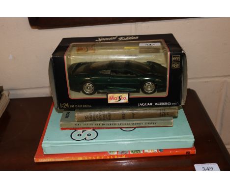 A Maisto die-cast model of a Jaguar XJ220; a Stanley Gibbons stamp album and other stamp related books 