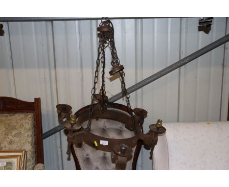A wrought metal six light chandelier 