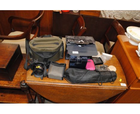 A Lumix FZ45 camera with various other digital cameras etc.
