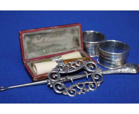 LOT OF SMALL SILVER ITEMS
including a planished button puller, two napkin rings, belt buckle and a case with two silver colla