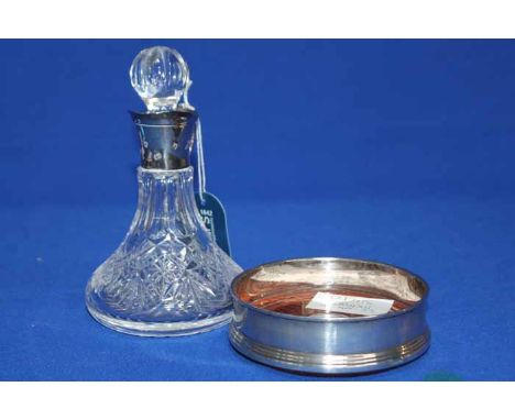 MODERN SILVER MOUNTED DECANTER
Sheffiled marks, single handle and pouring lip; together with a modern silver wine slide (2)