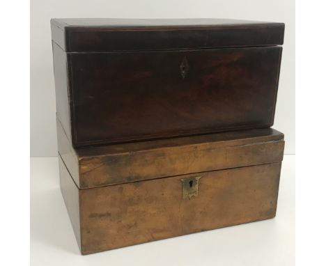 A late George III mahogany and cross-banded tea caddy of plain rectangular form, opening to reveal a central bowl recess, fla