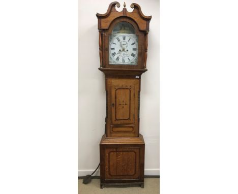 A 19th Century Manchester style oak cased long case clock, the eight day movement with painted arched dial and Roman numerals