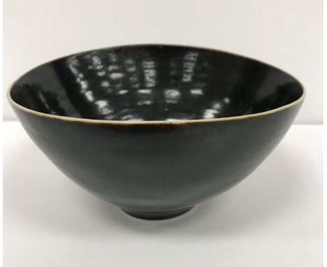 A Lucie Rie and Hans Coper elliptical studio pottery bowl with black glaze, bears both potters' stamps to base, approx 13.8 c