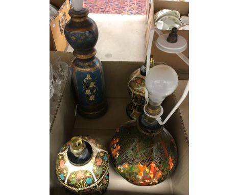 A hand-painted Kashmir lacquered table lamp, together with two similar table lamps and a wooden table lamp with painted flora