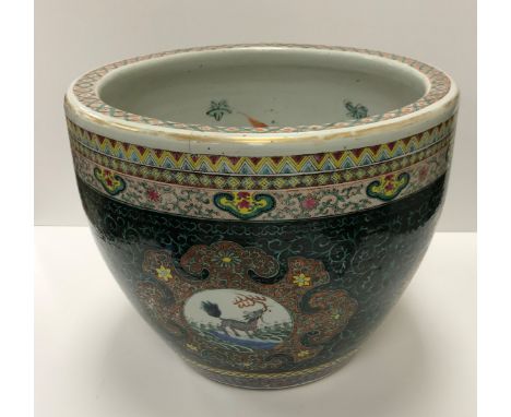 A 19th Century Chinese famille verte fish bowl, the exterior decorated with panels of kylin and birds on a foliate decorated 