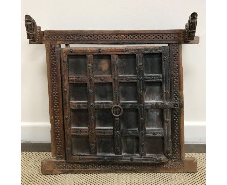 An Indian or Middle Eastern wall panel as a door with stylised horse decoration over a lattice work panel, 58 cm wide x 55 cm