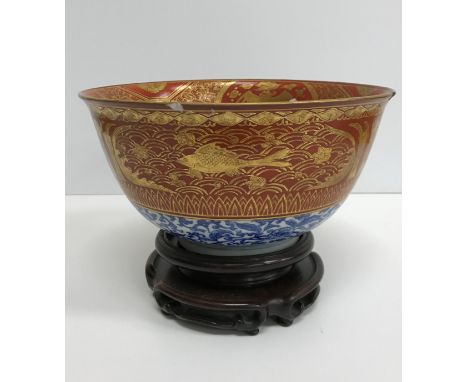 A Chinese oxide red and gilt banded blue and white deep bowl, the centre medallion decorated with phoenix within similarly de