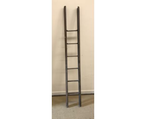 A 19th Century oak folding library ladder, each of the six rungs of inset flattened form folding to the interior as a pole wi