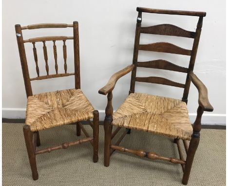 A 19th Century fruitwood and elm rush seat ladder back elbow chair, 61 cm wide x 50 cm deep x 98.5 cm high, together with a r