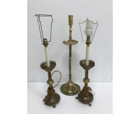 A bell metal altar style candlestick in the 17th Century manner raised on a petal foot 68.5 cm high together with a pair of V