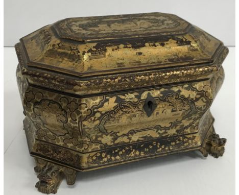 A 19th Century black lacquered and chinoiserie decorated two section tea caddy of bombe form, the hinged lid opening to revea