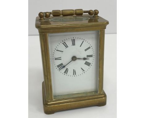 A circa 1900 brass cased carriage clock, the enamelled dial with Roman numerals, raised on a bracket foot base, 11 cm high no