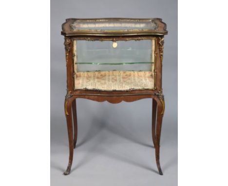 A 19th century French kingwood bijouterie table, or low vitrine with gilt-metal mounts, fitted with a single glass shelf and 