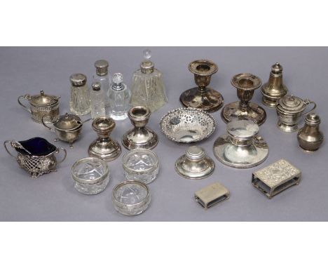 A collection of various silver condiments, silver-mounted glass items, two pairs of dwarf candlesticks, a sweetmeat dish, two