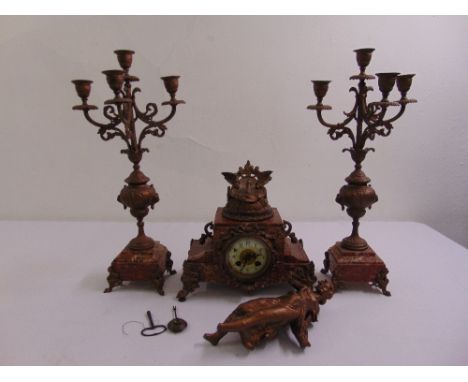 A 19th century French gilded metal and marble clock set flanked by two five light matching candelabra, the enamel clock dial 