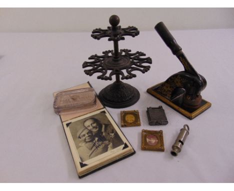A quantity of collectables to include two miniature photograph frames, a Metropolitan Policemans whistle, rubber stamp holder