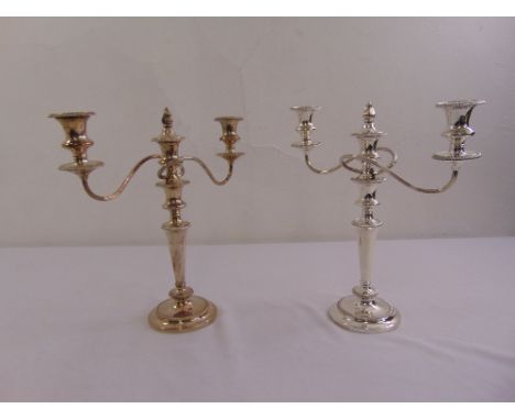 A pair of Garrard silver plated two light candelabra, tapering cylindrical on raised circular bases with flambé finials