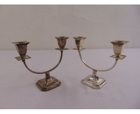 A pair of silver two light candelabra on raised octagonal bases, Birmingham 1936