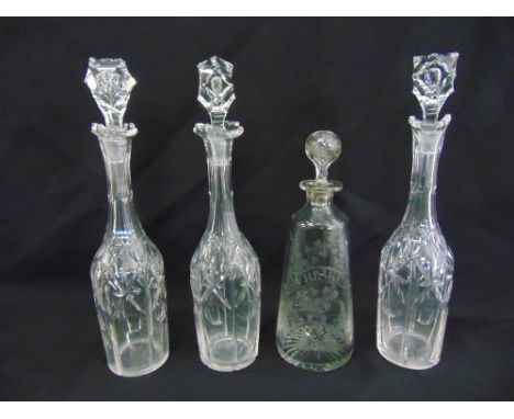 A whisky decanter and a set of three Victorian wine decanters with faceted drop stoppers