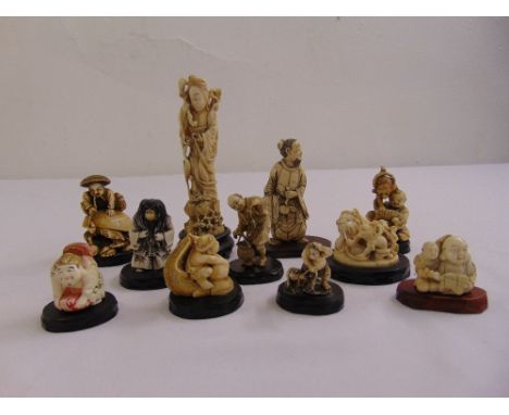 A quantity of oriental carved bone and composition netsuke on original hardwood stands (11)