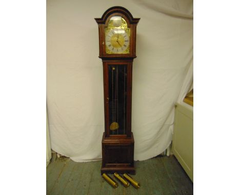 An oak striking long case clock with brass dial, silvered chapter ring, Roman numerals, glazed hinged door to include three w