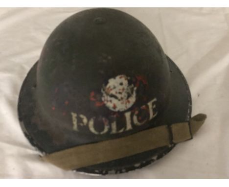 An original 1939 police helmet with WWII service medal and whistle on chain