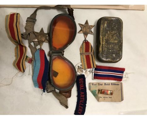 An original WWII 8th army medal collection with desert goggles, first aid kit and ribbons