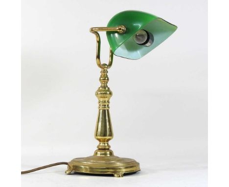 A brass desk lamp, 20th century, with a green glass shade38cm high