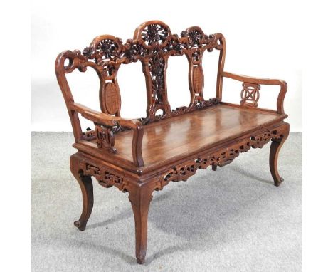 A Chinese carved hardwood bench, with a carved back and solid seat130w x 51d x 97h cm