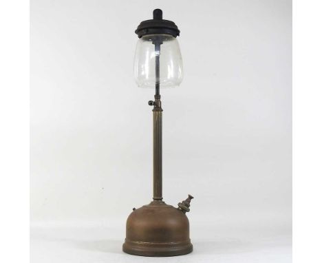 An early 20th century brass Tilley lamp, with a fluted stem and clear glass shade61cm high