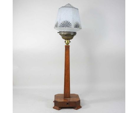 An Art Deco walnut table lamp, circa 1930, with herringbone inlaid edges, on a canted square base, with an opaque glass shade