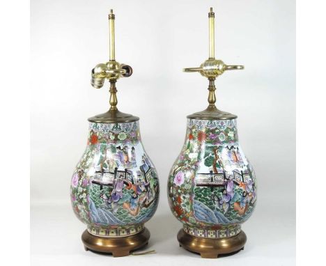 A pair of Chinese Canton porcelain table lamps, 20th century, decorated with figures with brass mounts60cm highCondition repo